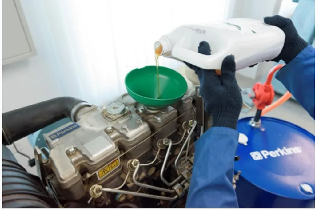 Oil being poured into a Perkins engine