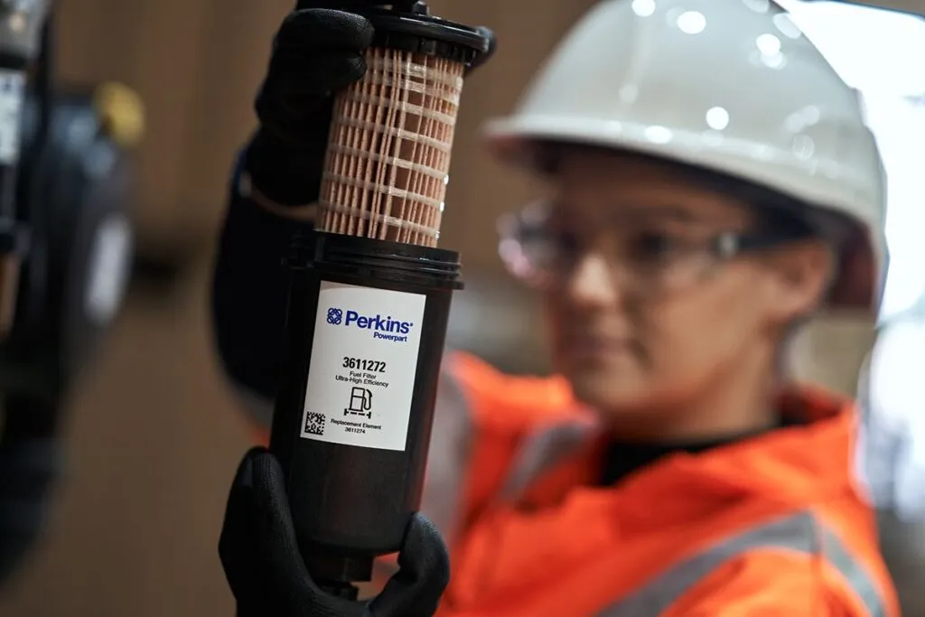 Engineer holding a genuine Perkins fuel filter